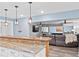 Open basement featuring a wet bar with granite counters, a living room area, and a pool table room at 109 Hawks Bnd, Canton, GA 30115