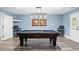 Basement game room featuring a pool table with decorative lighting, hardwood floors, and comfortable chairs at 109 Hawks Bnd, Canton, GA 30115