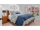 Comfortable bedroom featuring cozy bedding, a side table, and plantation shutters at 109 Hawks Bnd, Canton, GA 30115