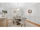 A lovely dining room with hardwood floors, modern light fixture, decor, and wainscoting at 109 Hawks Bnd, Canton, GA 30115