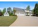Spacious two-story home with an attached two-car garage and a lush green lawn in a serene setting at 109 Hawks Bnd, Canton, GA 30115