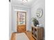 Cozy foyer with wood floors, shuttered glass door, cabinet and decor accents at 109 Hawks Bnd, Canton, GA 30115
