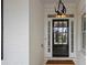 Close-up of the front door with black finish and decorative glass panels, framed by white trim and sidelights at 109 Hawks Bnd, Canton, GA 30115