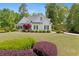 Charming two-story home with manicured lawn, mature shrubs, and a driveway leading to a two-car garage at 109 Hawks Bnd, Canton, GA 30115