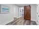 Charming hallway with a rustic barn door and stylish flooring, adds character to the home at 109 Hawks Bnd, Canton, GA 30115