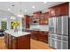 Spacious kitchen with stainless steel appliances, marble countertops, and ample cherry cabinet space at 109 Hawks Bnd, Canton, GA 30115