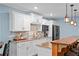 Charming kitchen with white cabinets, granite countertops, and a view of barstool seating at 109 Hawks Bnd, Canton, GA 30115