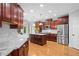 Gourmet kitchen with stainless steel appliances, marble countertops, and cherry cabinets at 109 Hawks Bnd, Canton, GA 30115