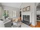Comfortable living room with a fireplace, natural light, and stylish furnishings at 109 Hawks Bnd, Canton, GA 30115