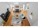 A bird's eye view of a living room with a fireplace, hardwood floors, and vaulted ceilings at 109 Hawks Bnd, Canton, GA 30115