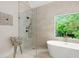 Spa-like bathroom with standing shower, free-standing tub and a large window at 109 Hawks Bnd, Canton, GA 30115