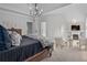 Spacious main bedroom with sitting area, fire place, tv, and a decorative chandelier at 109 Hawks Bnd, Canton, GA 30115