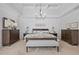 Bright main bedroom features a decorative wood accent wall, tray ceilings, and plush carpeting at 109 Hawks Bnd, Canton, GA 30115