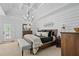 A bedroom with a paneled wall, tray ceiling, dresser, and a doorway to the exterior at 109 Hawks Bnd, Canton, GA 30115