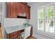 A charming office nook includes a granite countertop, dark wood cabinets, and a window with views at 109 Hawks Bnd, Canton, GA 30115