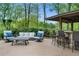 Outdoor covered living space with comfortable seating and an outdoor bar at 109 Hawks Bnd, Canton, GA 30115