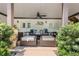 Covered outdoor patio featuring cozy seating, ceiling fan and access to the backyard at 109 Hawks Bnd, Canton, GA 30115