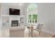 Bright sitting area with fireplace, built-in shelves, vaulted ceiling, and large window at 109 Hawks Bnd, Canton, GA 30115