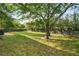 Picture of a large backyard with lush green grass, privacy fence, mature trees, and a tire swing at 1758 Bridgestone Ct, Marietta, GA 30066