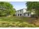 Spacious backyard with lush green grass, privacy fence, and views of the home's exterior at 1758 Bridgestone Ct, Marietta, GA 30066