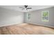 Bedroom with wood floors, two windows, and a ceiling fan, offering a bright and comfortable space at 1758 Bridgestone Ct, Marietta, GA 30066