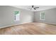 Bright bedroom with hardwood floors, two windows, and a ceiling fan at 1758 Bridgestone Ct, Marietta, GA 30066