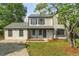 Charming two-story home featuring new siding, dark shutters, covered porch and a well-manicured front lawn at 1758 Bridgestone Ct, Marietta, GA 30066