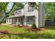 A two-story home with a covered porch and a well-maintained lawn creating a cozy curb appeal at 1758 Bridgestone Ct, Marietta, GA 30066