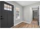 A bright and welcoming foyer with hardwood floors and a new front door at 1758 Bridgestone Ct, Marietta, GA 30066