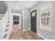 Inviting foyer with hardwood floors, a view of the fireplace, and a staircase leading to the upper level at 1758 Bridgestone Ct, Marietta, GA 30066