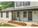 A covered front porch with stone accents provides a welcoming entrance to this charming two-story home at 1758 Bridgestone Ct, Marietta, GA 30066