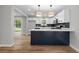Modern kitchen with white cabinetry, stainless steel appliances, and a blue kitchen island at 1758 Bridgestone Ct, Marietta, GA 30066