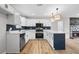 Bright kitchen featuring white cabinets, stainless appliances, and stone countertops with a decorative backsplash at 1758 Bridgestone Ct, Marietta, GA 30066