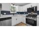 Kitchen highlights white cabinetry, stone countertops, stainless steel appliances, and a decorative backsplash at 1758 Bridgestone Ct, Marietta, GA 30066