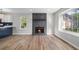 Open-concept living room featuring a stone fireplace, hardwood floors, and natural light at 1758 Bridgestone Ct, Marietta, GA 30066