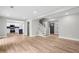Open concept living area with wood floors, connecting to a kitchen and staircase with a sleek, modern design at 1758 Bridgestone Ct, Marietta, GA 30066