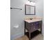 Bathroom with vanity, mirror, and tiled backsplash offering a clean and classic design at 2400 Honey Ct, Mcdonough, GA 30252