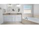 Bathroom with a soaking tub and a white dual vanity for a luxurious feel at 2400 Honey Ct, Mcdonough, GA 30252