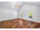 Main bedroom featuring wood floors, high ceilings, large windows, and neutral paint colors at 2400 Honey Ct, Mcdonough, GA 30252