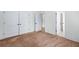 Bedroom with neutral carpet, white trim, and lots of natural light from the open doorway at 2400 Honey Ct, Mcdonough, GA 30252
