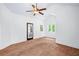 Bedroom with ceiling fan, carpeted flooring and a door, and views of the yard at 2400 Honey Ct, Mcdonough, GA 30252