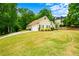 Single-story home with an attached garage and large front yard with lush landscaping at 2400 Honey Ct, Mcdonough, GA 30252