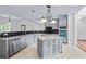 Bright kitchen featuring gray cabinetry, granite countertops, stainless appliances, and a center island at 2400 Honey Ct, Mcdonough, GA 30252