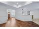 Open-concept living room with hardwood floors, access to kitchen, and lots of natural light at 2400 Honey Ct, Mcdonough, GA 30252