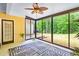 Bright sunroom with sliding glass doors and ceiling fan providing backyard views at 2400 Honey Ct, Mcdonough, GA 30252