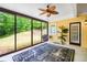 Relaxing sunroom featuring sliding glass doors, ceiling fan, and decorative rug overlooking the backyard at 2400 Honey Ct, Mcdonough, GA 30252