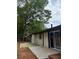 Backyard features a brick house, stone pavers, and mature trees at 2401 Winshire Drive, Decatur, GA 30035