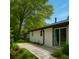 Landscaped backyard featuring a stone walkway, manicured lawn, and mature trees at 2401 Winshire Drive, Decatur, GA 30035