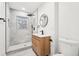 Bathroom with modern vanity, walk-in shower featuring stylish tile and rainfall showerhead at 2401 Winshire Drive, Decatur, GA 30035