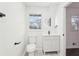 Bright bathroom with updated vanity, fixtures, window, and stylish circular mirror at 2401 Winshire Drive, Decatur, GA 30035
